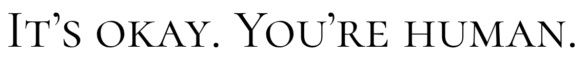Zwarte achtergrond met grote witte typografie: “IT’S OKAY. YOU’RE HUMAN.”